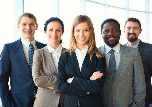 young-businesswoman-with-co-workers-scaled